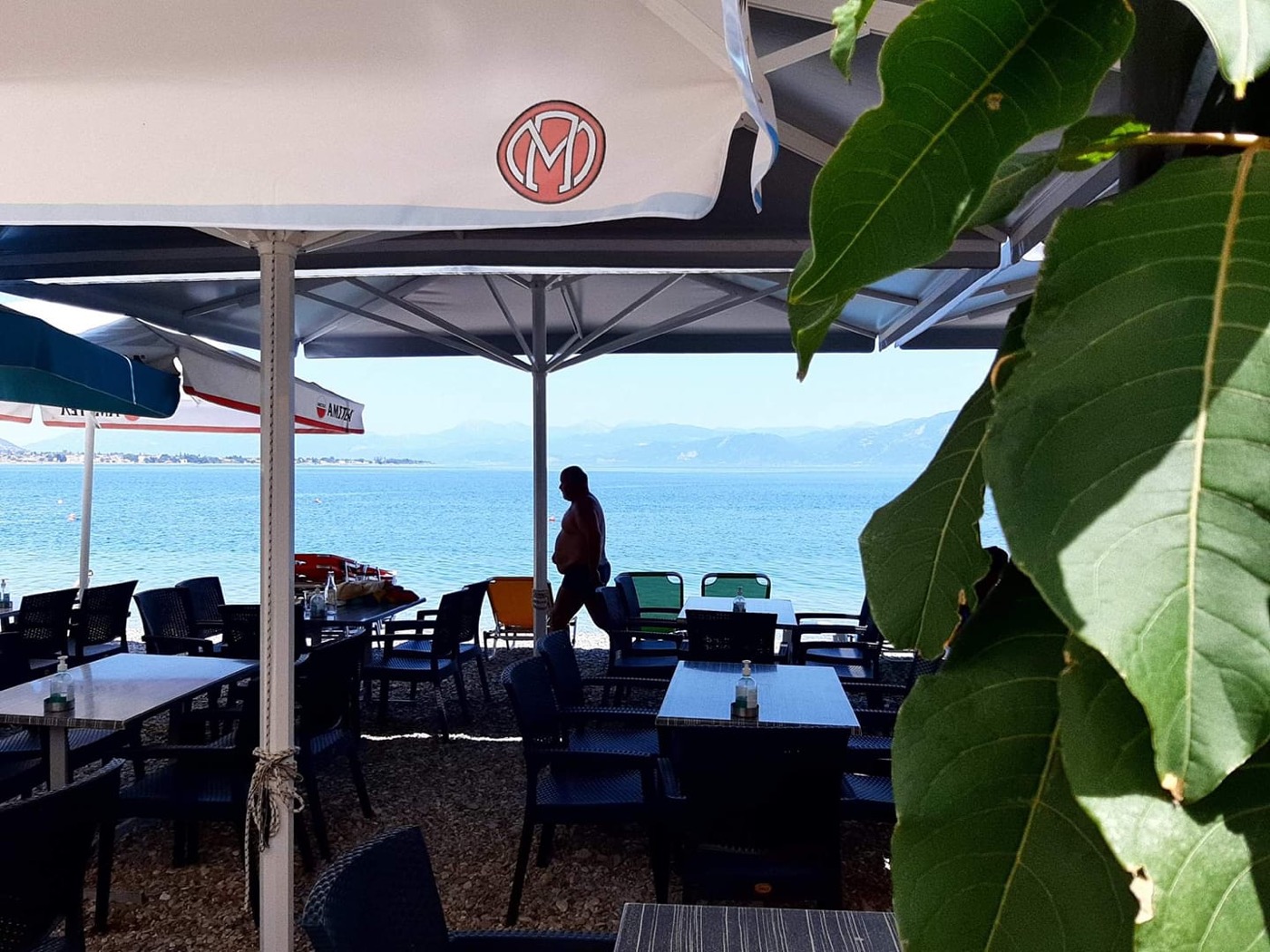 Guests dining at Ellinikon terrace under a red sky at sunset, Akoli Beach, Gulf of Corinth